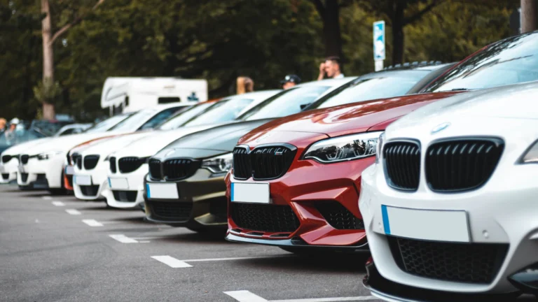 Row of cars parked for sale on a dealership lot